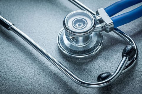 Auscultator on grey background medicine concept