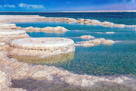 The evaporated salt forms bizarre crystal shapes on the surface of the water. Israeli coast, warm