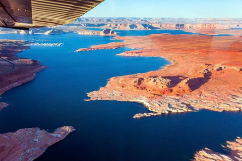 Landscape under the wing of an airplane. Lake Powell is a reservoir on the Colorado River located