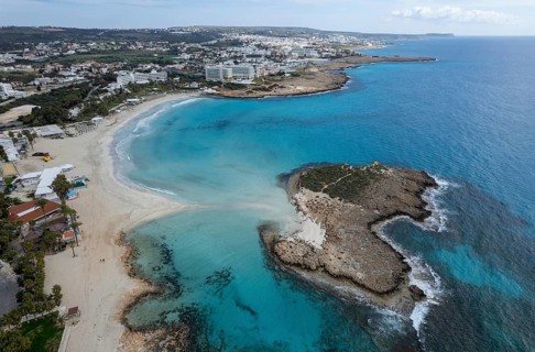Aerial drone view of the coastline of empty beach in winter. Summer holidays. Nissi beach bay Ayia