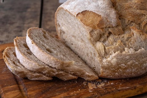 Sliced organic wheat bread and flour on a table.Alsace, France
