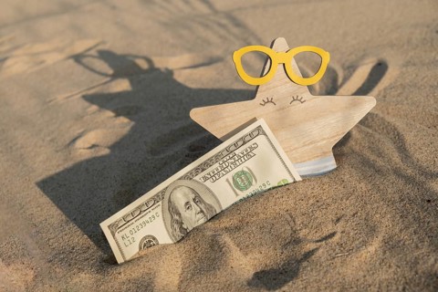 Money american hundred dollar bills in sandy beach with starfish. Concept finance saving money for