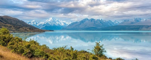 Scenic reflection of Mount Sefton and Mount Cook at lake Pukaki, South Island of New Zealand