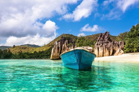 Old fishing boat on Tropical beach at Curieuse island Seychelles. Horizontal shot