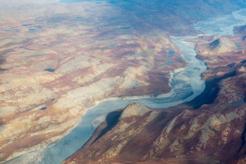 Landscape of Greenland seen from the air in summer with rocky surface, lakes and ground moraine,