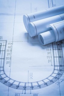 Rolled up construction plans building and architecture concept