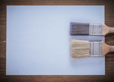 Clean sheet of paper and paintbrushes top view image