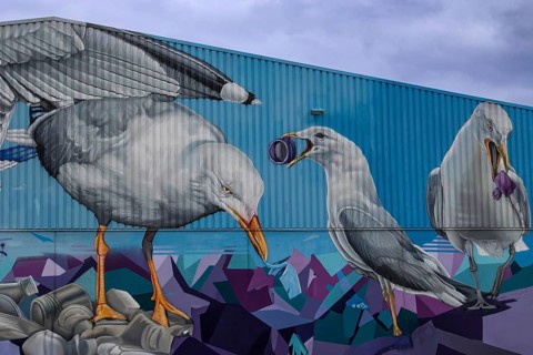 Large mural of seagulls picking up rubbish, an artistic representation of recycling, Hamburg