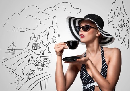 Creative vintage photo of a beautiful pin up girl drinking tea on sketchy landscape background