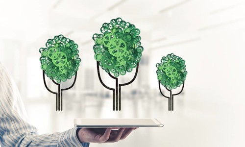Close of businessman holding tablet pc with green tree made of gears and cogwheels. Mixed media