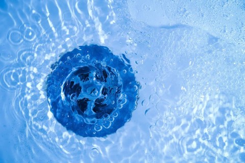 Close-up of bath tub sink with water running away