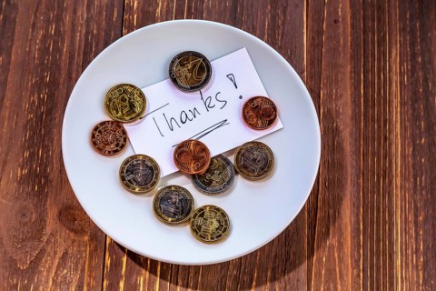 A plate with coins for tips or toilet charges. In English language Austria