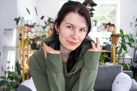 Large portrait Joyful emotions of a woman in the hood in her home in a bright modern interior with