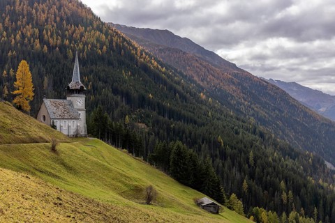 Church of St. Peter with golden larch in autumn, Monstein, Davos, Grisons, Switzerland