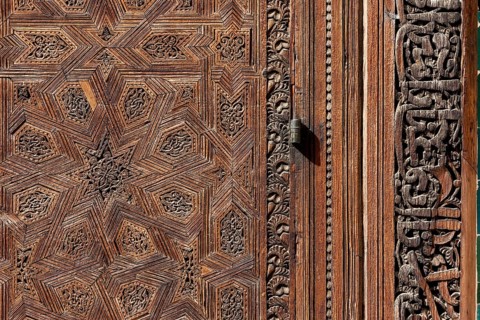 Traditional oriental door detail at the courtyard of madrasa Bou Inaniya in the medina of Fes,