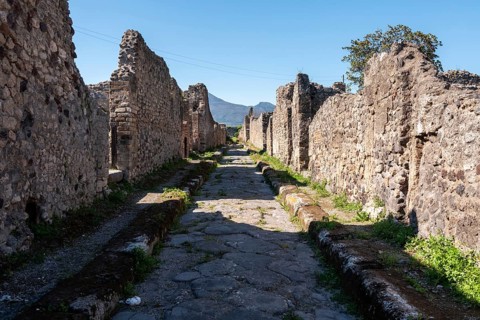 POMPEII, ITALY, MAY 04, 2022, A beautiful typical cobbled street in the ancient city of Pompeii,