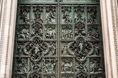 Entrance bronze door to the Duomo. Milan, Italy.