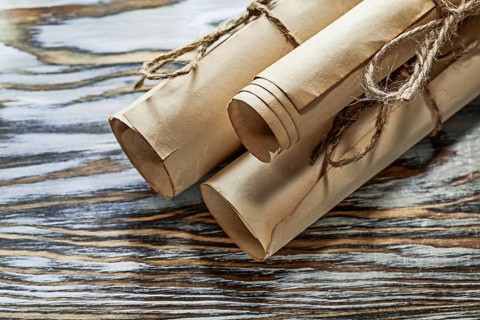 Medieval corded paper rolls on wooden board