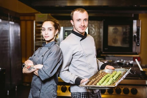 Profession preparation confectionery products. Caucasian man and woman two employees colleague