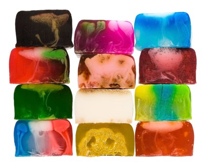 Set of several handicraft coloured nice cream soap bars in stack isolated on white background