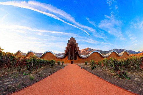 The magnificent modern architecture of Bodegas Ysios. Bright flaming colors of the sunset. Journey