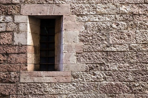 Assisi Italy : Window on medieval stone wall
