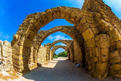 Picturesque ruins of the ancient seaport Caesarea. Excursion to the Archaeological Park of the