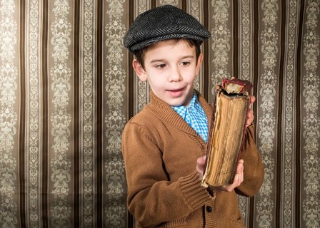 Child with red vintage book. Vintage clothes and hat