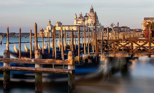 Gondola jetty, Venetian gondolas with the church of Santa Maria della Salute in the background,