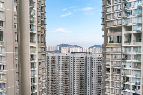 The view of residential neighborhood and skyscrapers from rooftop in Hong Kong