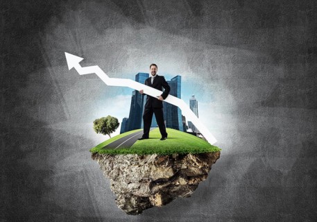 Conceptual image of young and confident business man in suit holding big white arrow in hands