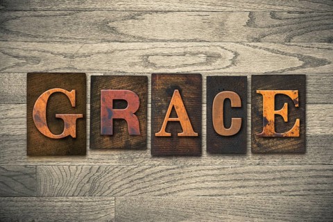 The word GRACE written in wooden letterpress type