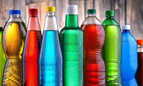 Plastic bottles of assorted carbonated soft drinks in variety of colors