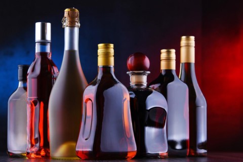 Composition with bottles of assorted alcoholic beverages