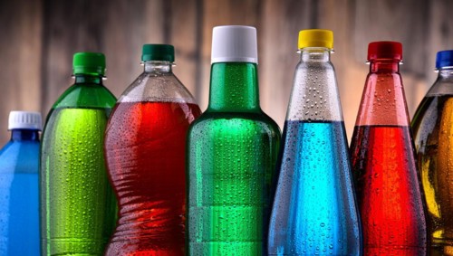 Plastic bottles of assorted carbonated soft drinks in variety of colors