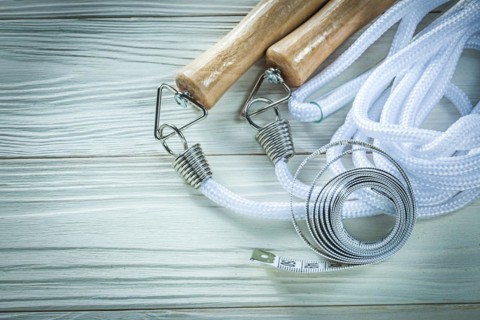 Skipping rope Tape measure on wooden board Fitness concept