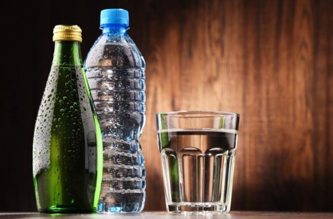 Composition with glass and bottles of mineral water