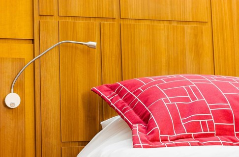 A design red pillow in a modern style bedroom