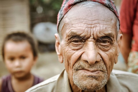Damak, Nepal, circa May 2012: Old frowning man with beard and wrinkles on his face at Nepali