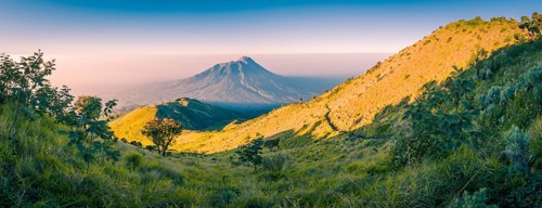 Panoramic photo of mountains surrounding Mount Merbabu near Yogya in central Java province in
