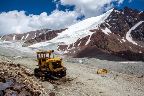 Abandoned broken bulldozer. Kok-Airyk pass, Tien Shan mountains, Kyrgyzstan
