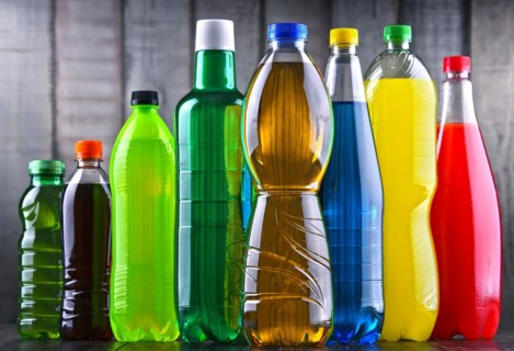 Plastic bottles of assorted carbonated soft drinks in variety of colors