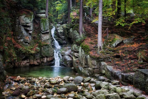 Waterfall in autumn forest of Karkonosze Mountains, Przesieka, Poland
