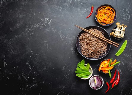 Ingredients for making stir-fried noodles soba. Cut fresh vegetables, mushrooms, boiled soba