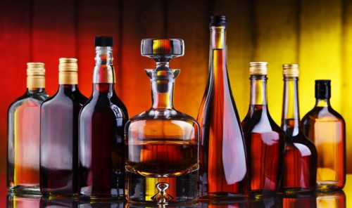 Composition with bottles of assorted alcoholic beverages