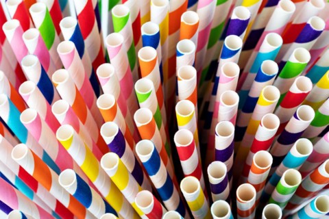 Colourful paper drinking straws on a white background