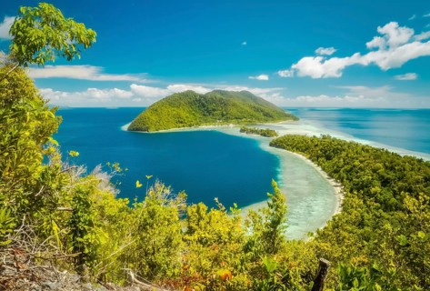 Photo of clear blue sea and greenery of Kri island, Raja Ampat, West Papua, Indonesia. In this
