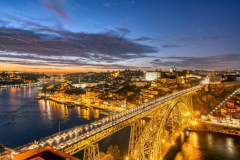 Porto with the Dom Luis I bridge and the Douro river after sunset