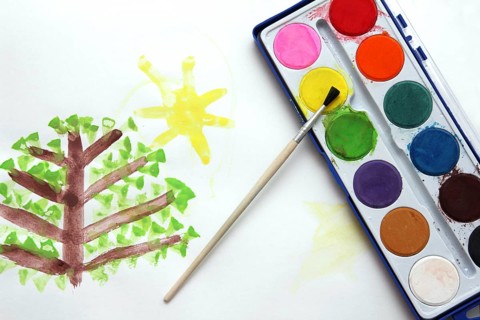 Children's drawing and watercolor paints with brush