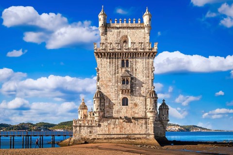 Landmark of Belem tower, Lisbon, Portugal at blue summer day sky with clouds. Medieval